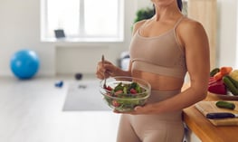 Woman eating a salad, symbolizing healthy eating habits that may not be enough to counter a slowing metabolism.